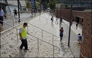 People walk down a stairway leading to a parking structure across from Pauley Pavilion on the UCLA campus after flooding from a broken 30-inch water main under nearby Sunset Boulevard inundated a large area of the campus in the Westwood section of Los Angeles.