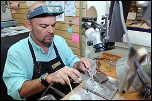 Jeweler Murray Cadenhead works on repairing a piece of jewelry at Perry's Fine Jewelers on Independence Boulevard in Wilmington, N.C. 