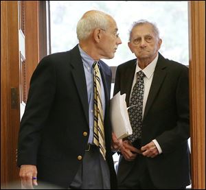 Attorney Thomas Douglas, left, heads back into Lucas County Common Pleas Court with his client, Robert W. Conboy, 84, who was sentenced to six months in jail.