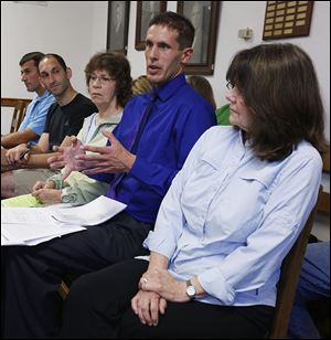 Guest speakers Dr. Brian Fink, second from right, and Dr. Eileen Metress, right, speak about the dangers of pesticides.