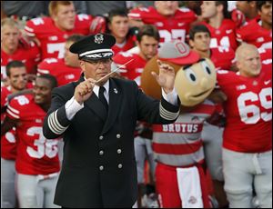 Then Ohio State University marching band director Jon Waters leads the band in 