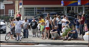 Spectators watch as crews work to remove a tractor-trailer rig that crashed into Tony Packo's Cafe.