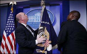 The presidential flag is readied in the James Brady Press Briefing Room of the White House today in Washington.