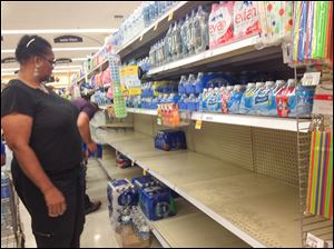People buy water in the Dixie Highway Kroger in Frenchtown Township in Monroe County. 