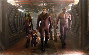From left, Zoe Saldana, the character Rocket Racoon, voiced by Bradley Cooper, Chris Pratt, the character Groot, voiced by Vin Diesel and Dave Bautista in a scene from 