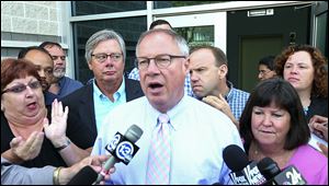 Toledo Mayor D. Michael Collins announces that the Toledo water crisis is over during a news conference early today.