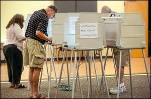 Gary Merkel casts his ballot at the Bedford Branch Library.