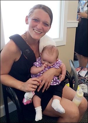  Jamie Shipley, 28, a recovering heroin addict, holds her 4-month-old daughter, Kaylee, at First Step Home in Cincinnati.