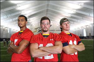 Toledo’s Michael Julian, left, Phillip Ely, center, and Logan Woodside are vying to be this year's starting quarterback. 