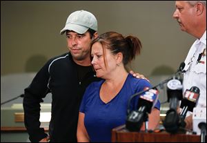 Tom and Christy Turner at news conference with Monroe County Sheriff Dale Malone, right, Friday, August 8, 2014, at the Bedford Township Government Center in Bedford Township, after pleading for the return of their daughter Hayley Turner, 18. Haley Turner was reported missing Thursday evening.