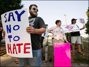 Dan Denton of Toledo and others protest outside the Ted Nugent concert.
