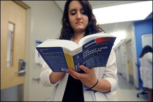 Dr. Emily Krennerich holds a 20th edition copy of 'The Harriet Lane Handbook' at the Johns Hopkins Children's Center in Baltimore.
