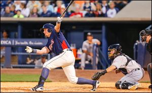 Toledo Mud Hens player James McCann (13) drives in a run against the Louisville Bats  during the seventh inning at Fifth Third Field, Friday, July 18, 2014.