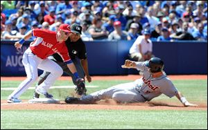 Toronto Blue Jays third baseman Steve Tolleson tags out Detroit Tigers baserunner Nick Castellanos at third base during a steal attempt the fifth inning Sunday in Toronto.