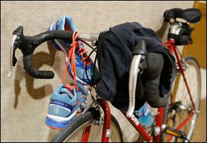 Some of the gear needed to compete in the Sylvania Triathlon on Sunday. Items include running shoes, a bicycle, and a swim suit.