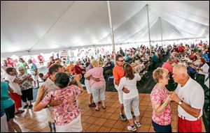 People dance in the packed tent during the second annual Polka Party Picnic at St. Hyacinth Catholic Church in Toledo. Plans to raise funds for a new community center were announced at the festival.