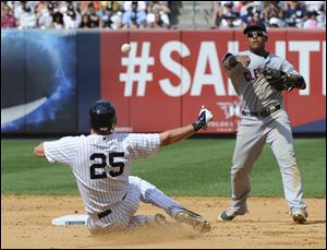The Yankees' Mark Teixeira is out at second base as Cleveland Indians shortstop Jose Ramirez relays the ball to first to complete the double play Sunday at Yankee Stadium in New York. The Indians won 4-1.