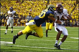 Michigan's Drake Johnson tackles Central Michigan's Jason Wilson during an Aug. 31, 2013, game at Michigan Stadium in Ann Arbor. The The redshirt sophomore missed last season after tearing his ACL during that game, and he didn’t resume practicing until this summer.