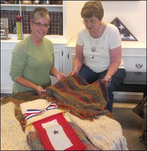 Marty Ross, left, and event organizer Sherryann Franks will honor relatives of military personnel with the presentation of Blue Star Service Banners in Wauseon.