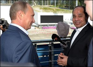 Russian President Vladimir Putin, left, meets with Egyptian President Abdel-Fattah el-Sissi, right, in the Russian Black Sea resort of Sochi, Russia today. El-Sissi is on his first visit to Russia. 