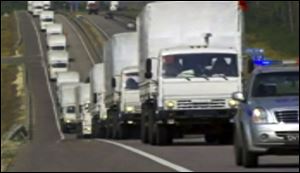 A convoy of white trucks with humanitarian aid on its way to Voronezh, Russia, today. The international Red Cross, which is due to coordinate the operation, said it had no information on what the trucks were carrying or where they were going. 