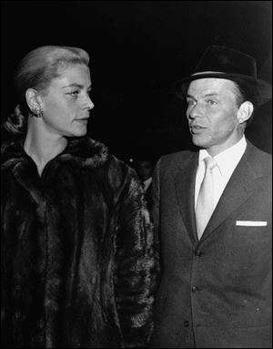 Frank Sinatra escorts Lauren Bacall to the Hollywood preview of his film, 