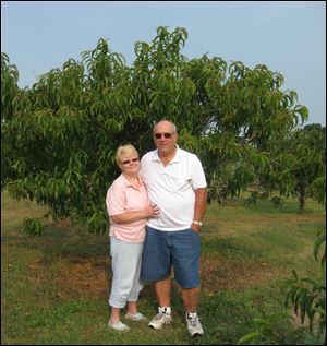 Jennifer and Bill Ely stand in front of a nectarine tree that was standed from a pit.