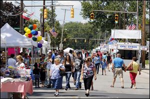 People walk down the midway of the 2013 Birmingham Ethnic Festival.