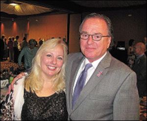 Julie Abbey, trustee and fund-raising chairman, and husband John Abbey, emcee, trustee, and clean water and maintenance chairman enjoy the evening of the D.O.V.E. dinner.   