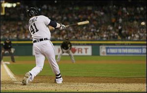 Detroit Tigers designated hitter Victor Martinez connects for a two-run single during the seventh inning of an interleague baseball game against the Pittsburgh Pirates, Wednesday, Aug. 13, 2014 in Detroit. (AP Photo/Carlos Osorio)