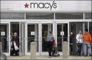 Earnings at Macy’s, the second-largest U.S. department-store firm, trailed expectations after discounts to lure shoppers eroded profit.