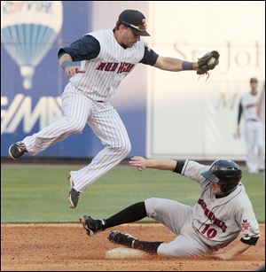 Mud Hens second baseman Brandon Douglas leaps to avoid Indianapolis’ Blake Davis as he slides into second after being tagged out Wednesday night at Fifth Third Field.