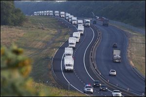 A convoy of white trucks with humanitarian aid moves from Voronezh towards Rostov-on-Don, Russia, early today.