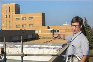 Andrew McClure, Collins Park Water Treatment Plant superintendent, points out the roofing replacement on Toledo’s treatment facility. The plant was built in 1941.