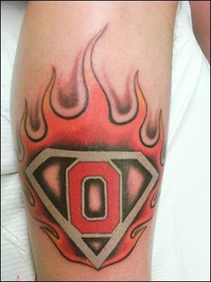 Terry Hoellrich, 57, of Defiance lives for Buckeyes football. He got his first Ohio State tattoo seven years ago. He now has 17, most of them sporting flames.