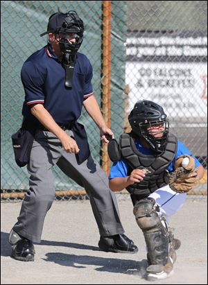 Brondes catcher Ethan Bennett, 9, makes the catch as Mr. Walton looks on.