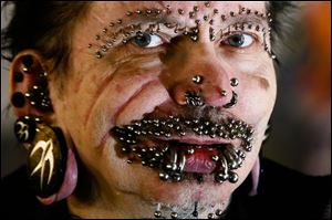 German Rolf Buchholz was refused entry to the Gulf city because of security concerns. The German man now has 453 piercings, including many in his face and genitals, according to Guinness World Records.