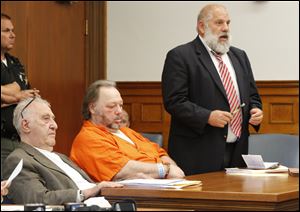 Defense attorneys Bobby Kaplan, left, and Pete Rost, right, with their client, Andrew Gustafson, center.