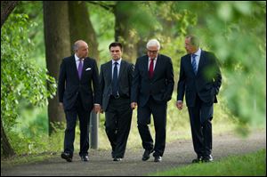 Foreign Ministers of France Laurent Fabius, Ukraine Pavlo Klimkin, Germany Frank-Walter Steinmeier and Russia Sergey Lavrov, from left, go for a walk before a meeting at the Guesthouse of Foreign Ministry Villa Borsig in Berlin, Sunday.