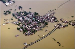 Houses in a residential area are partially submerged by monsoon floods at Nalanda district of Bihar, India, Sunday.
