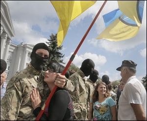 Friends and relatives say goodbye to volunteers Sunday in Kiev, Ukraine, before they were sent to the eastern part of Ukraine to join the ranks of special battalion 
