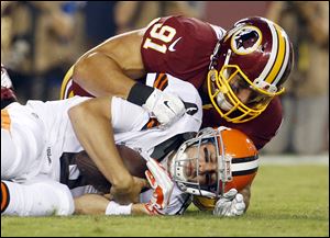 Washington Redskins outside linebacker Ryan Kerrigan sacks Browns quarterback Brian Hoyer during the first half.
