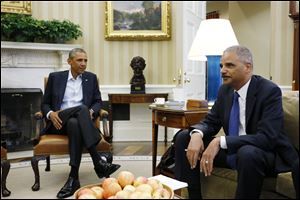 Obama said Attorney General Eric Holder, right, would travel to Ferguson this week to meet with FBI and other officials carrying out an independent federal investigation into Brown’s death.