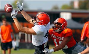 BG's Gehrig Dieter tries to catch a pass while being defended by Austin Valdez during the Falcons’ final football scrimmage Tuesday.