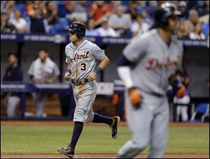 Detroit Tigers' Ian Kinsler (3) scores on a bases-loaded walk to Victor Martinez by Tampa Bay Rays relief pitcher Grant Balfour during the 11th inning.