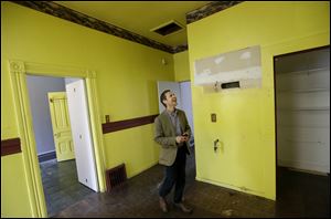 George Limperis, a realtor with Paragon Real Estate Group, walks through the kitchen of a property in the Noe Valley neighborhood in San Francisco.