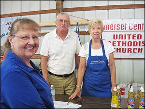 The Rev. Pat Pebley, left, pastor of Somerset Center United Methodist Church, helped George and Karen Buell at the Loaves and Fishes event.