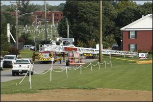 A Campbellsville Fire Department truck with the ladder extended remained at the scene where two firefighters were injured during an ice bucket challenge during a fundraiser for ALS on Thursday in Campbellsville, Ky. Officials say the ladder got too close to a power line and electricity traveled to the ladder, electrocuting the firefighters. 
