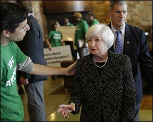 Federal Reserve Chair Janet Yellen, right, said it's still unclear when the national interest rate will rise.