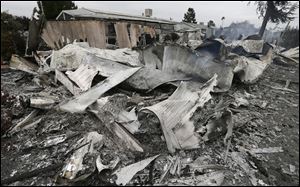 The remains of a mobile home are seen after a gas fire destroyed it as the result of a magnitude 6.0 earthquake Sunday, Aug. 24, 2014, at the Napa Valley Mobile Home Park, in Napa, Calif. A large earthquake caused significant damage and left at least three critically injured in California's northern Bay Area early Sunday.